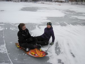My daughter and a friend sledding on the ice
